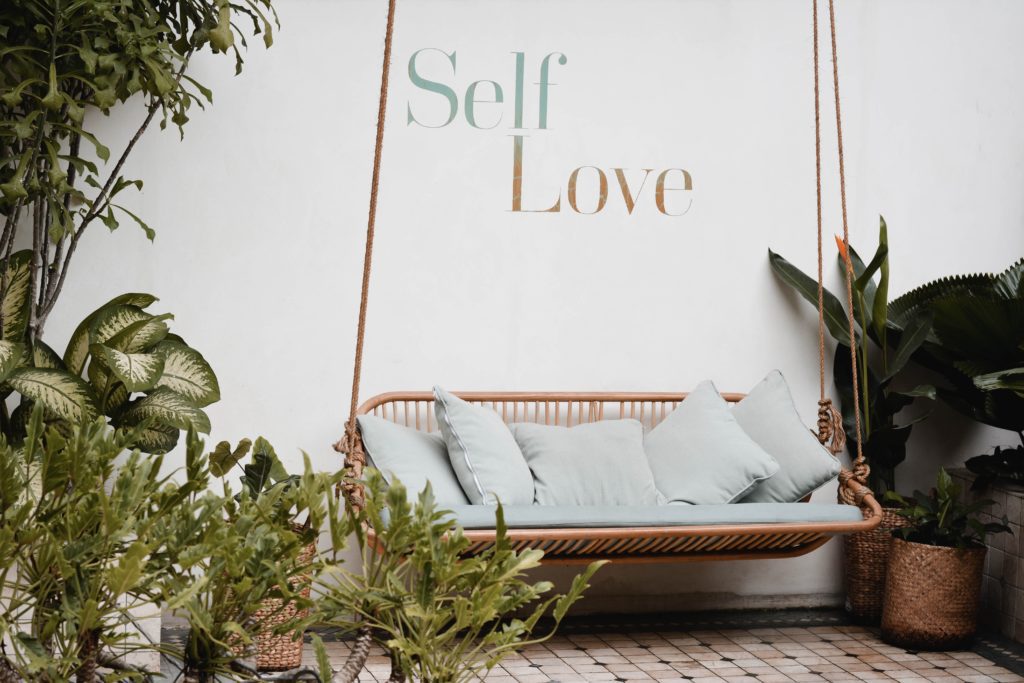 Image of an outdoor patio space with words Self Love on wall 